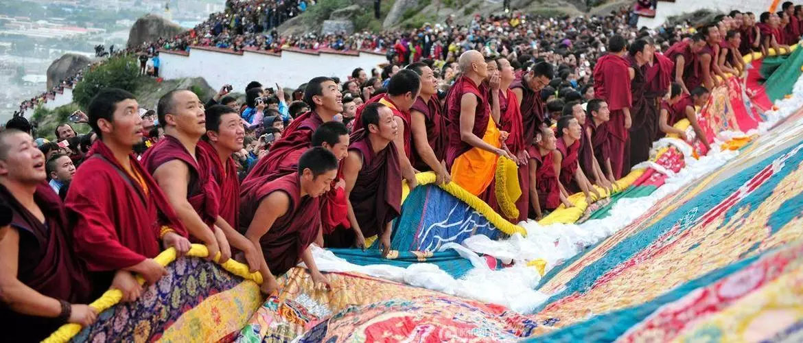 During Shoton Festival,  a huge thangka with Buddha spread out for people to worship.