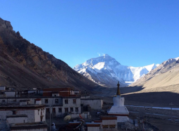 At the site of Rongbuk Monastery, you can view the highest mountain of the world brightly shining and clearly sparkling. The snowy peak seems happily to touch the blue sky. 