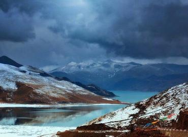 Lake Yamdrok is surrounded by snow-capped mountains in February.
