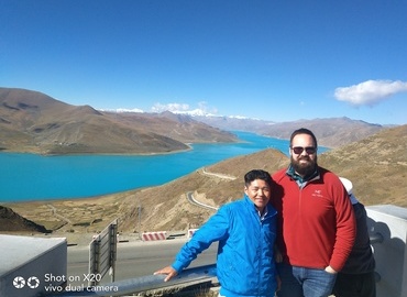 Our Tibetan tour guide and guest posed for a picture beside the beautiful Yamdrok Lake. Our Tibetan tour guide and guest posed for a picture beside the beautiful Yamdrok Lake.