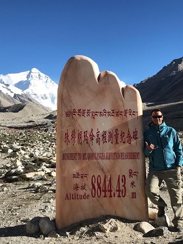 Tony is standing at the Mt. Everest Monument. 