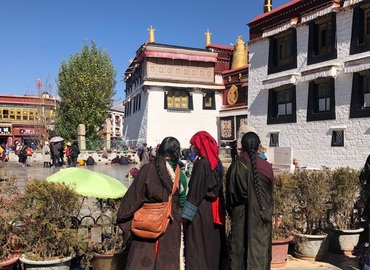 Three Tibetan women at the gate of Jokhang Temple.