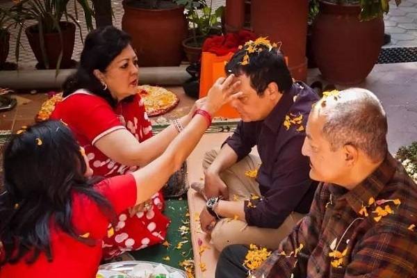 Elders put “tika” on the forehead of younger relatives to bless them.