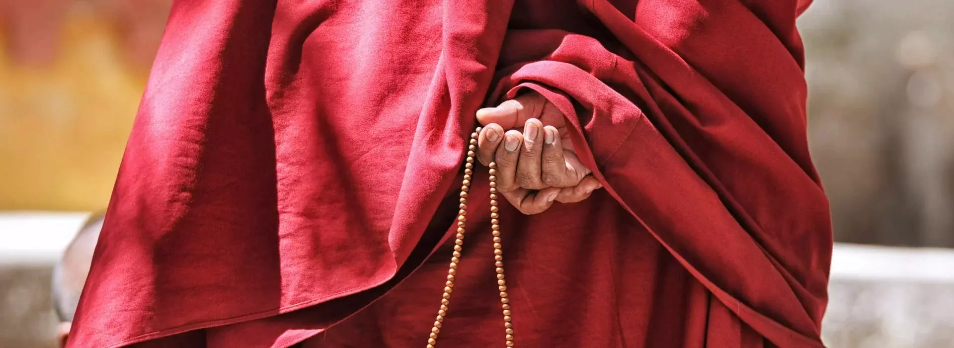 Tibetan monk with beads