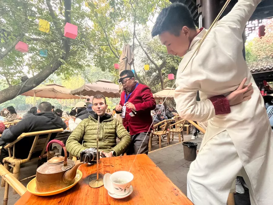 Long spout copper kettle pouring tea
